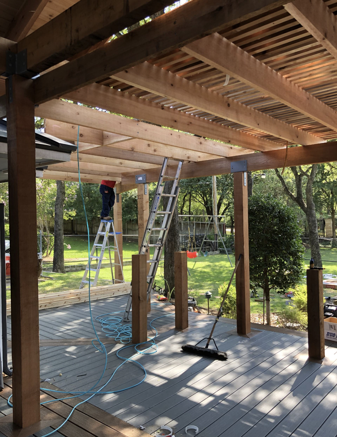 Large pergola patio project with beautiful deck being completed by Jenkins Roofing builders on home in Dallas, TX