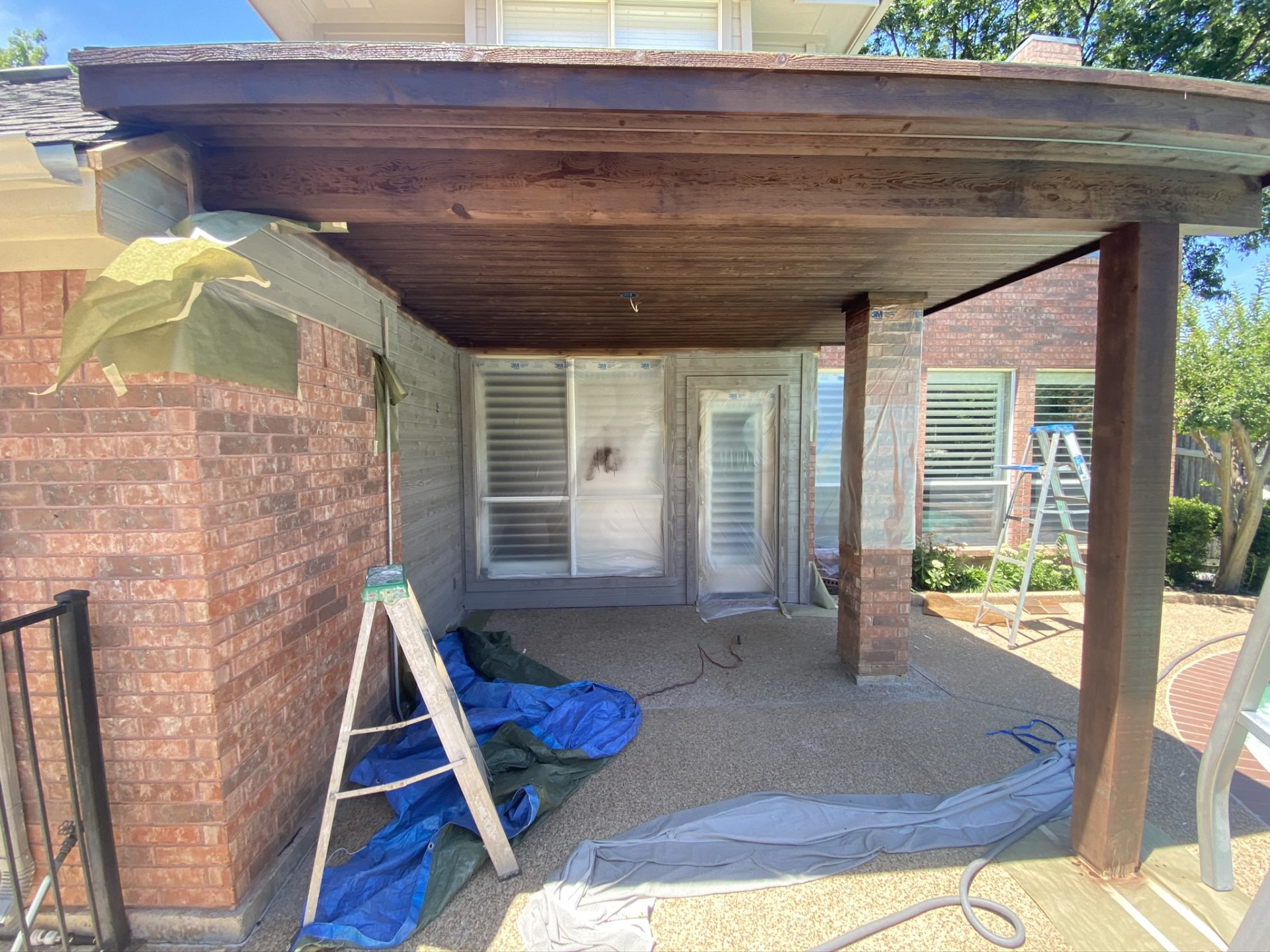 Construction of a patio roof that extends living space in an Arlington, TX homeowner's backyard.