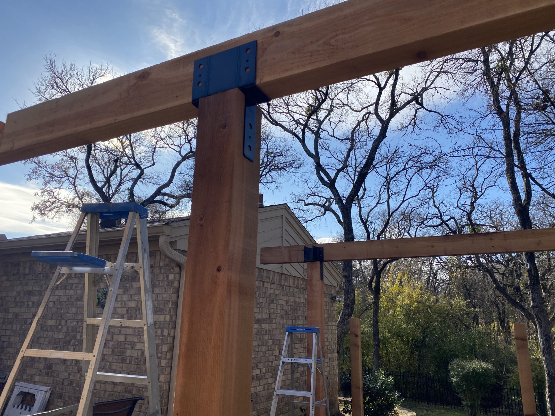 Support beams for a patio roof construction project in a residential home's backyard in North Texas.