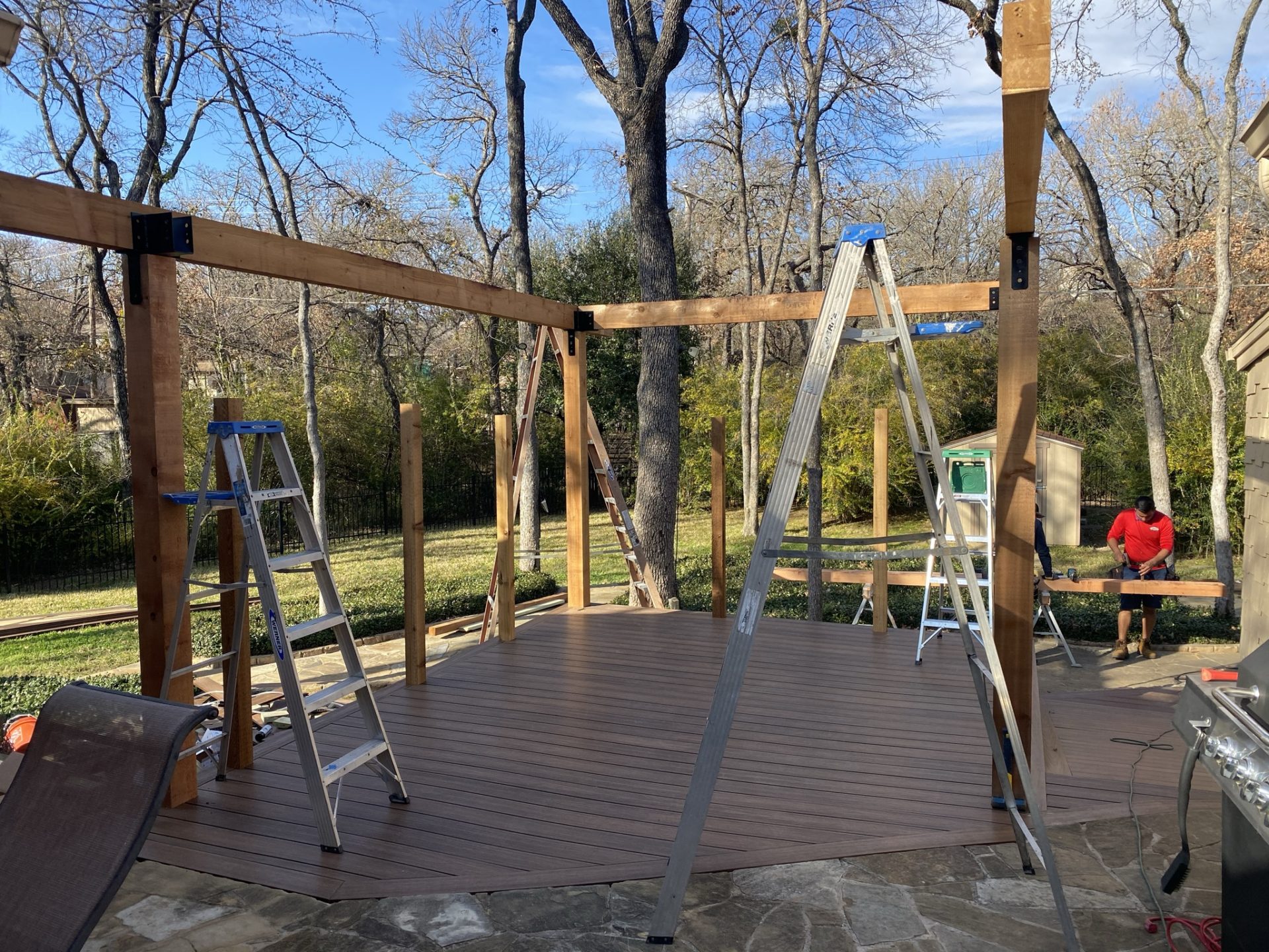Patio deck completed and 4 frame posts set up for patio roof installation.