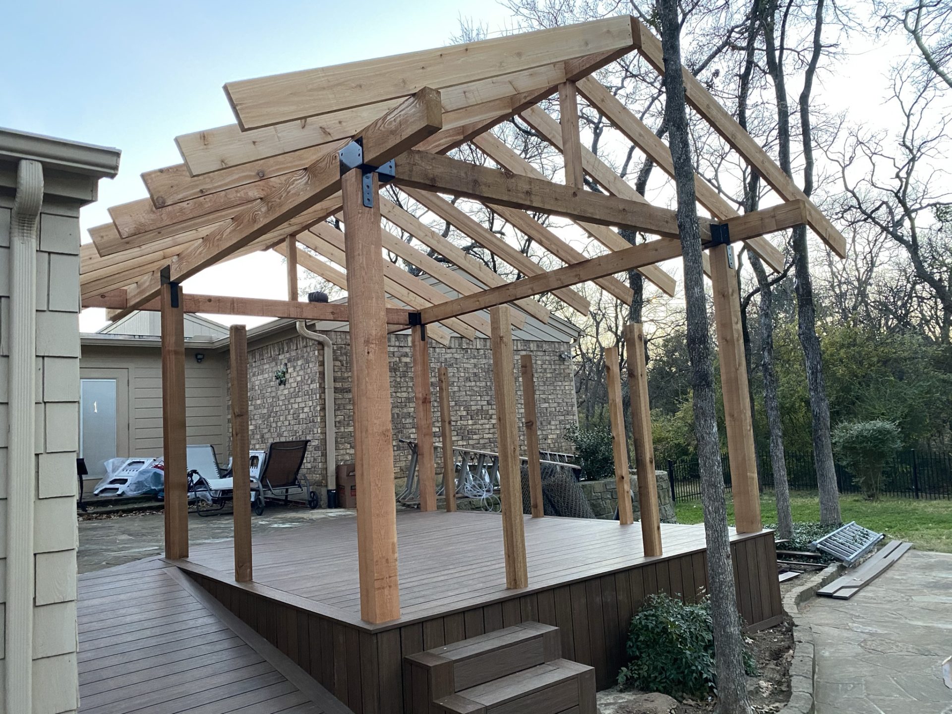 Patio deck completed and 4 frame posts set up for patio roof installation along with roof cross support beams.
