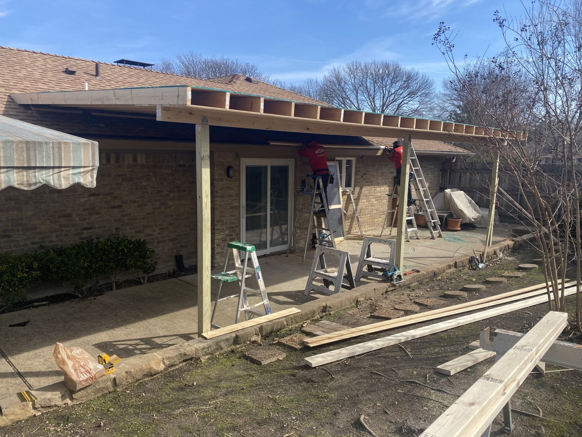 Jenkins Roofing and Construction workers working on an outdoor patio project in the Dallas Fort Worth area