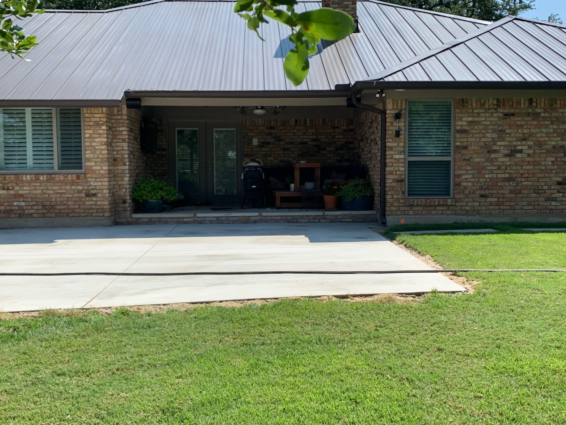 Concrete slab in the backyard of a home in North Texas, before pavilion style patio with roof is installed by Jenkins Roofing.