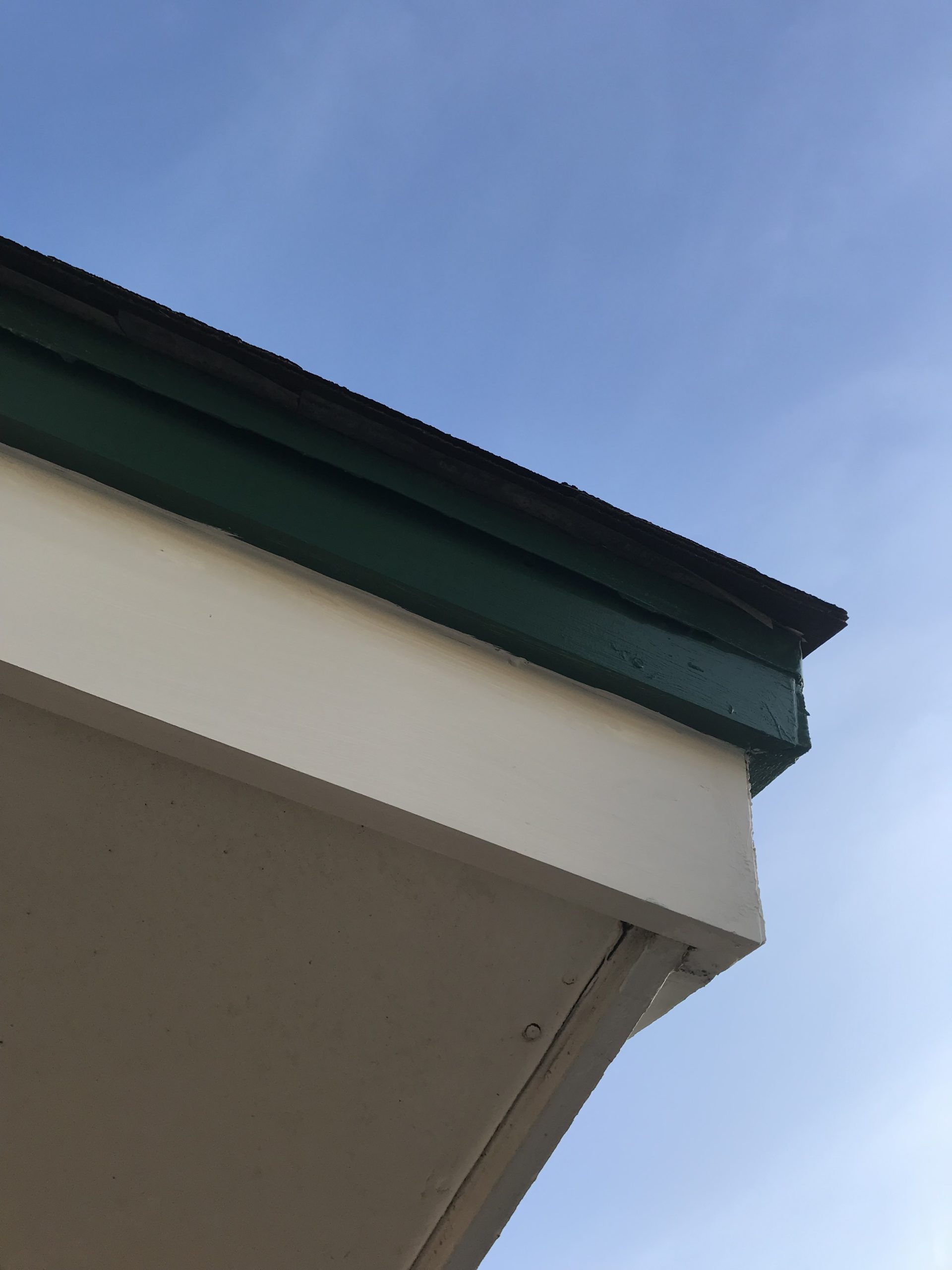 Repaired fascia damage on the side of a home underneath the roof in Arlington, TX.